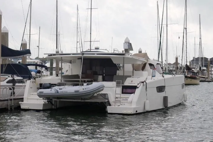 Cloud Nine Yacht Photos Pics 2020 Fountaine Pajot Astrea 42 Catamaran docked in a marina, rear view.
