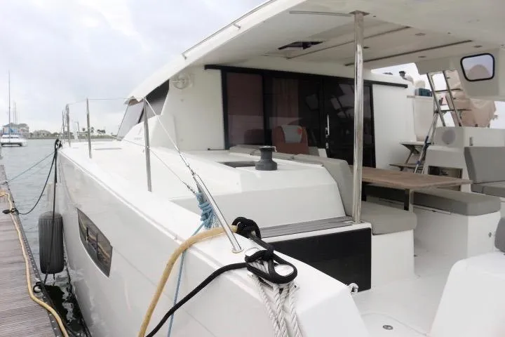 Cloud Nine Yacht Photos Pics 2020 Fountaine Pajot Astrea 42 Catamaran docked, showcasing spacious deck and modern design.