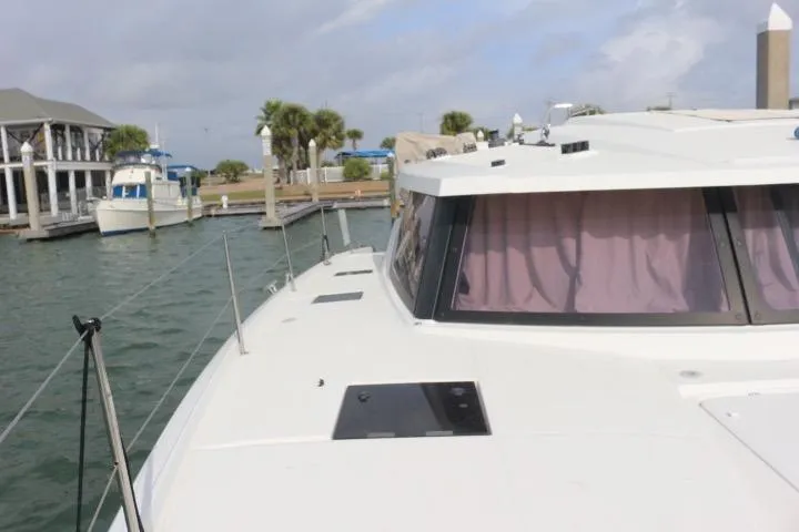 Cloud Nine Yacht Photos Pics 2020 Fountaine Pajot Astrea 42 Catamaran docked at marina with palm trees.