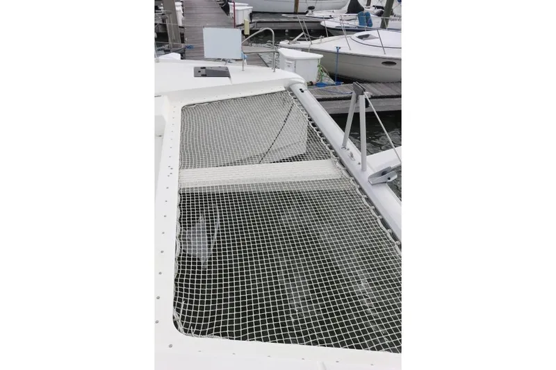 Cloud Nine Yacht Photos Pics 2020 Fountaine Pajot Astrea 42 Catamaran with netted deck, docked at marina.