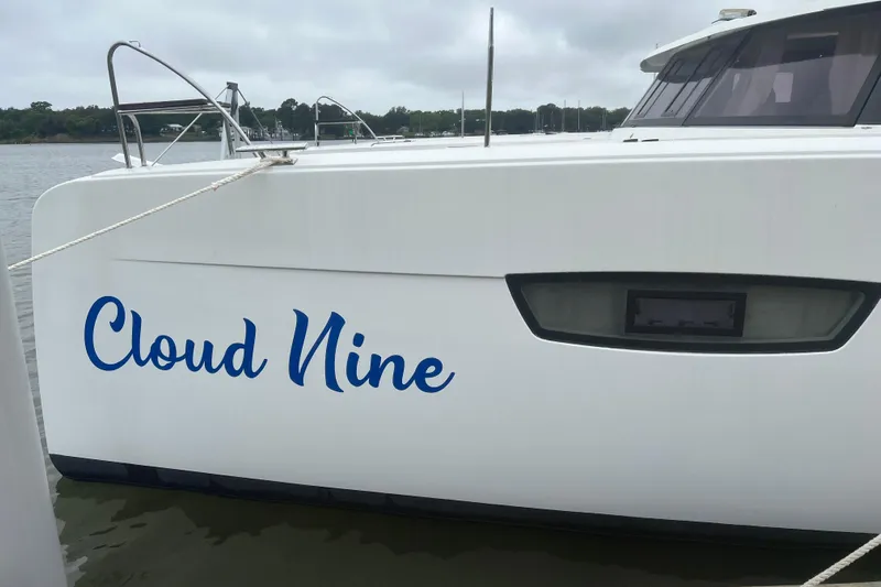 Cloud Nine Yacht Photos Pics 2020 Fountaine Pajot Astrea 42 Catamaran named "Cloud Nine" docked on a calm waterway.