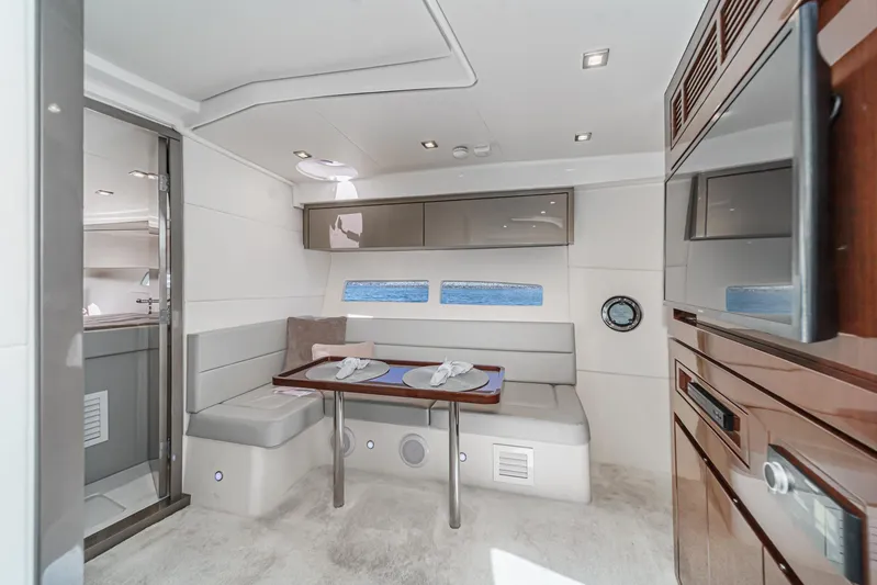 Adamas Yacht Photos Pics Luxurious interior of 2021 Schaefer 400 yacht with modern dining area and sleek design.