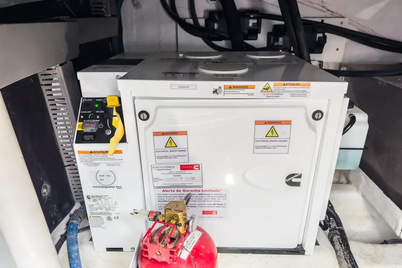 Adamas Yacht Photos Pics Electrical equipment in a Schaefer 400 yacht, 2021 model, with safety labels and fire extinguisher.