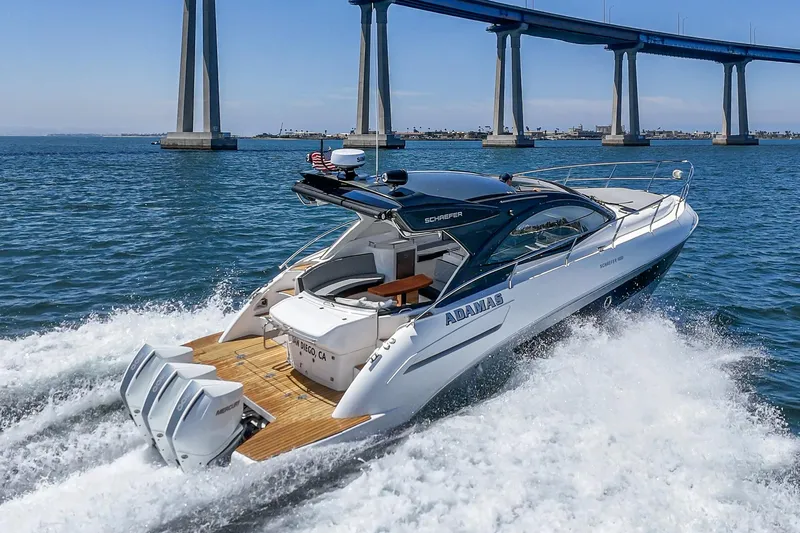 Adamas Yacht Photos Pics Luxury Schaefer 400 yacht cruising under a bridge, 2021 model, on a sunny day.