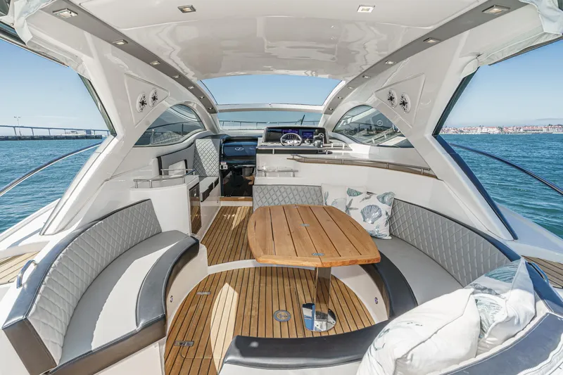 Adamas Yacht Photos Pics Luxurious 2021 Schaefer 400 yacht interior with elegant seating and wooden table.