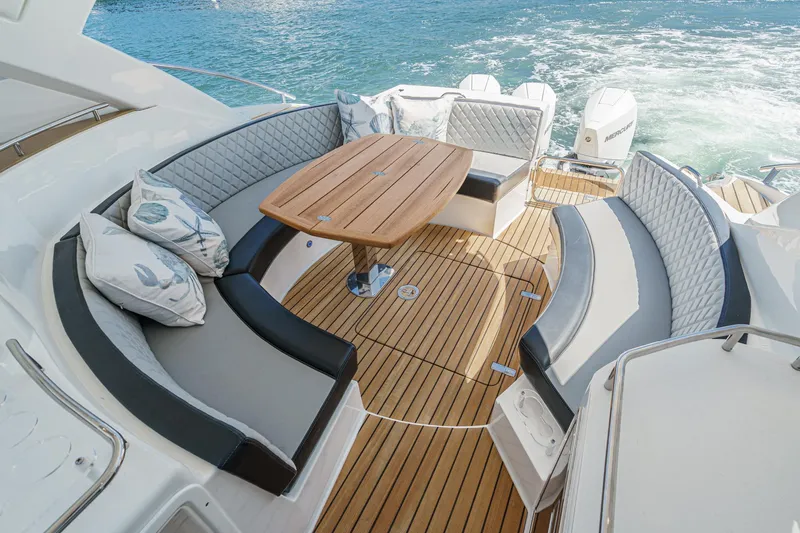 Adamas Yacht Photos Pics Luxurious Schaefer 400 yacht deck with elegant seating and wooden table, 2021 model.