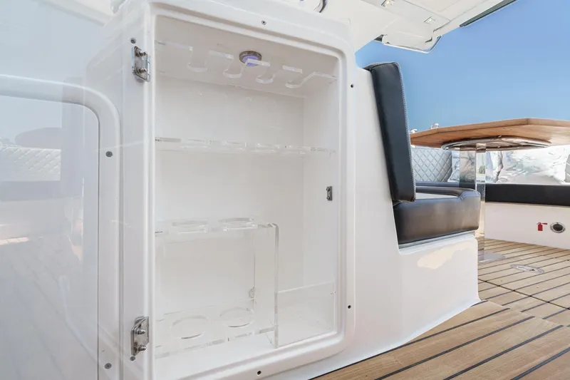 Adamas Yacht Photos Pics Open storage compartment on Schaefer 400 yacht, 2021 model, with seating and wooden deck.