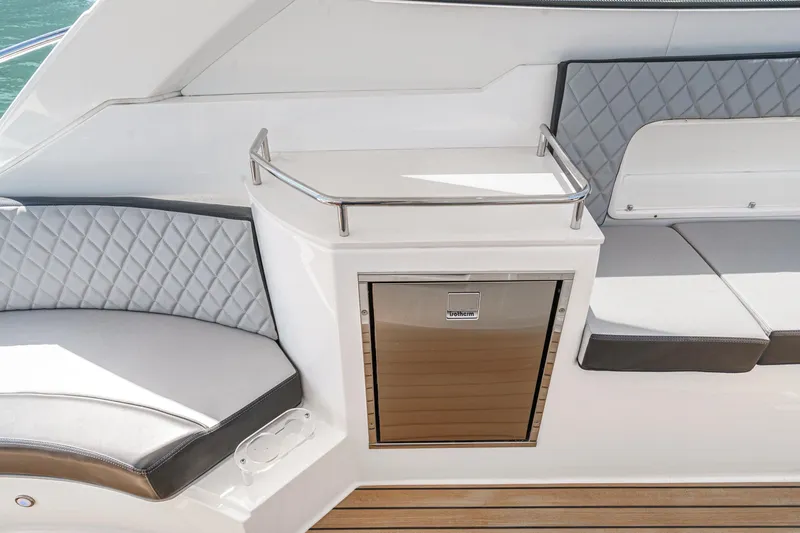 Adamas Yacht Photos Pics Luxury seating area on 2021 Schaefer 400 yacht with quilted cushions and sleek cabinetry.