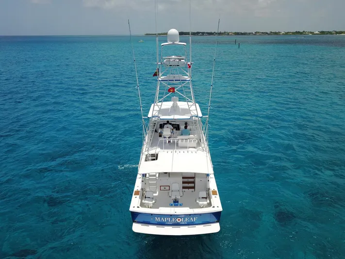 Maple Leaf Yacht Photos Pics 1981 Bertram Convertible yacht Maple Leaf cruising in clear blue ocean waters.