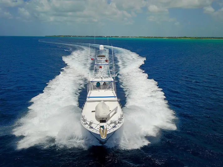 Maple Leaf Yacht Photos Pics 1981 Bertram Convertible yacht cruising on open blue water.