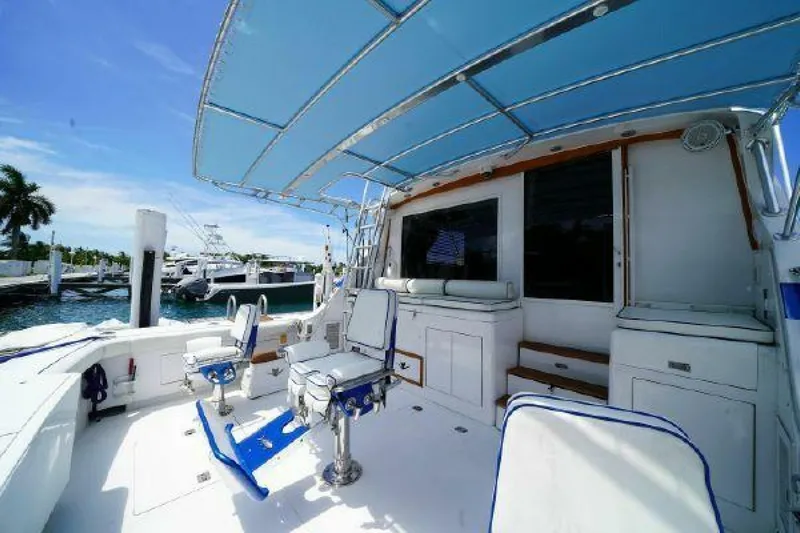 Maple Leaf Yacht Photos Pics 1981 Bertram Convertible boat with spacious deck and blue canopy.