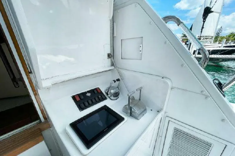 Maple Leaf Yacht Photos Pics Control panel on 1981 Bertram Convertible boat with tablet and switches.