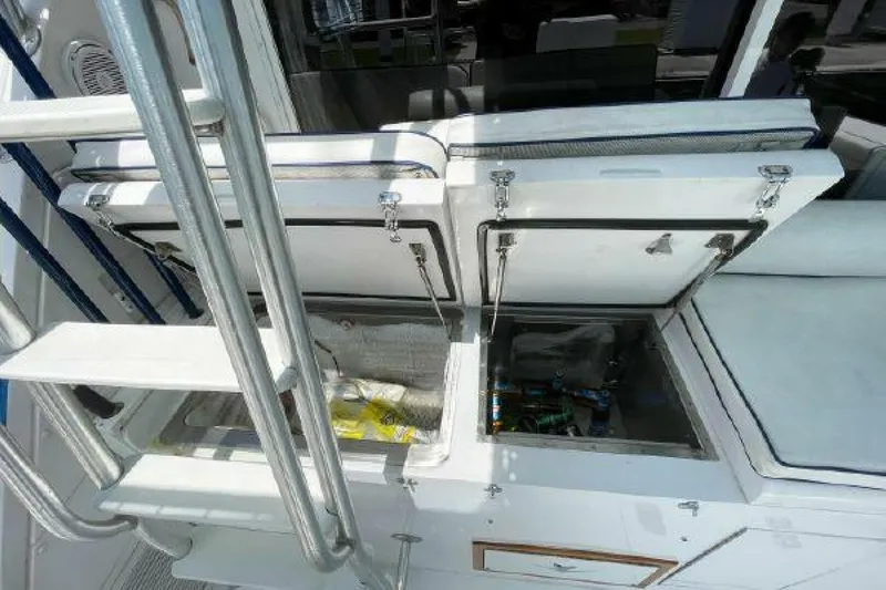 Maple Leaf Yacht Photos Pics 1981 Bertram Convertible boat with open storage compartments on deck.