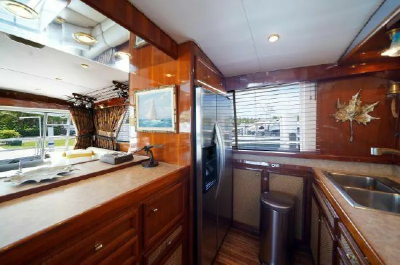 Maple Leaf Yacht Photos Pics 1981 Bertram Convertible yacht interior with modern kitchen and dining area.