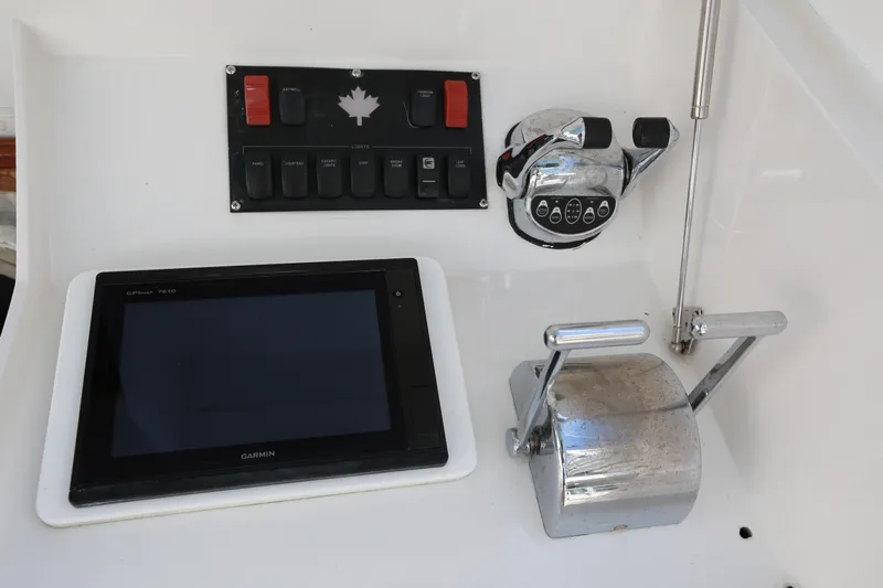 Maple Leaf Yacht Photos Pics 1981 Bertram Convertible boat controls with Garmin GPS and throttle levers.