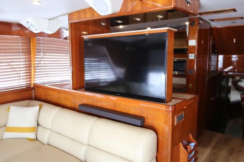 Maple Leaf Yacht Photos Pics Luxurious interior of 1981 Bertram Convertible yacht with TV and leather seating.