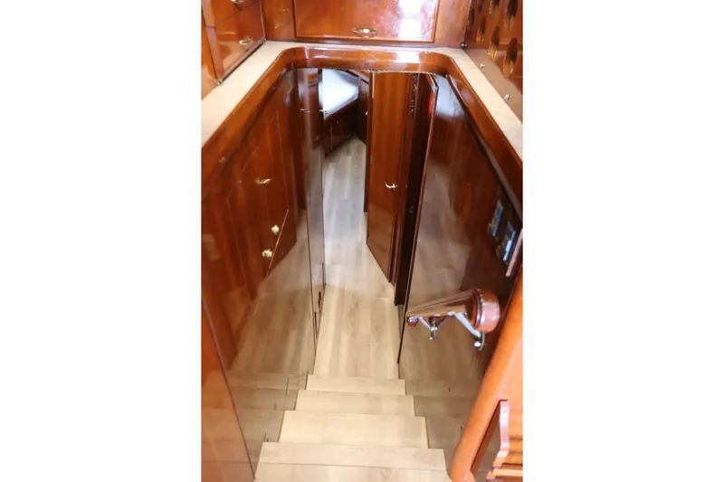 Maple Leaf Yacht Photos Pics Staircase with wooden cabinetry inside a 1981 Bertram Convertible yacht.