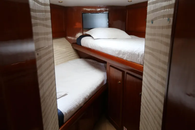 Maple Leaf Yacht Photos Pics 1981 Bertram Convertible cabin with wooden interior and twin beds.