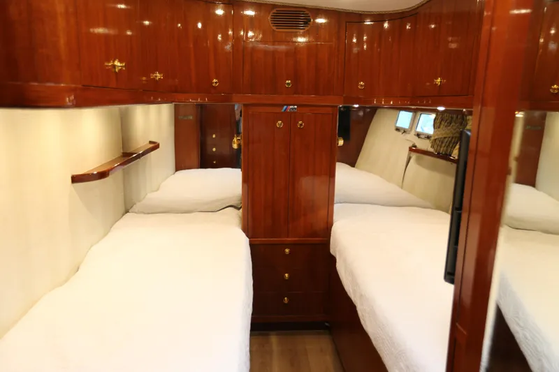 Maple Leaf Yacht Photos Pics Luxurious 1981 Bertram Convertible yacht cabin with twin beds and polished wood finish.