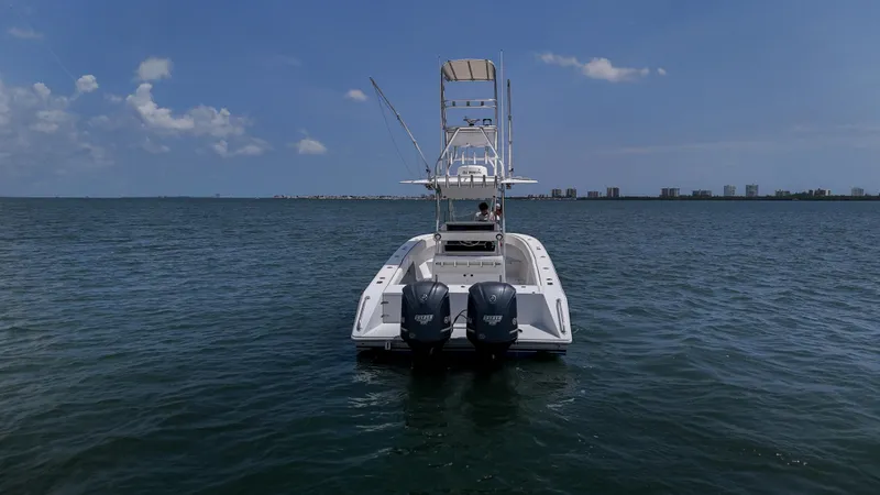  Yacht Photos Pics A 2001 Venture 34 boat with dual engines on open water under a clear sky.