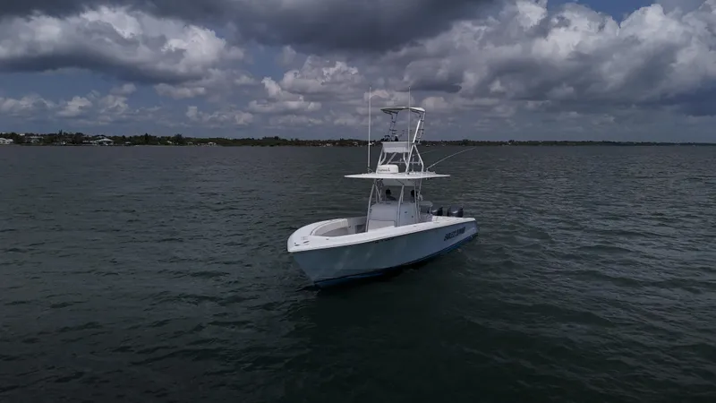  Yacht Photos Pics A 2001 Venture 34 boat on calm waters under a cloudy sky.