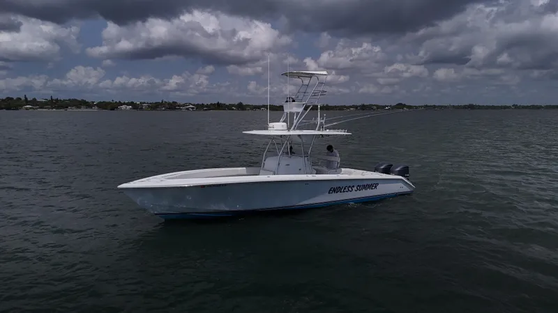  Yacht Photos Pics 2001 Venture 34 boat on calm water under cloudy sky.