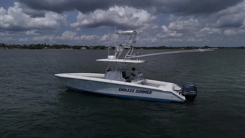  Yacht Photos Pics 2001 Venture 34 boat named "Endless Summer" on calm waters under cloudy skies.