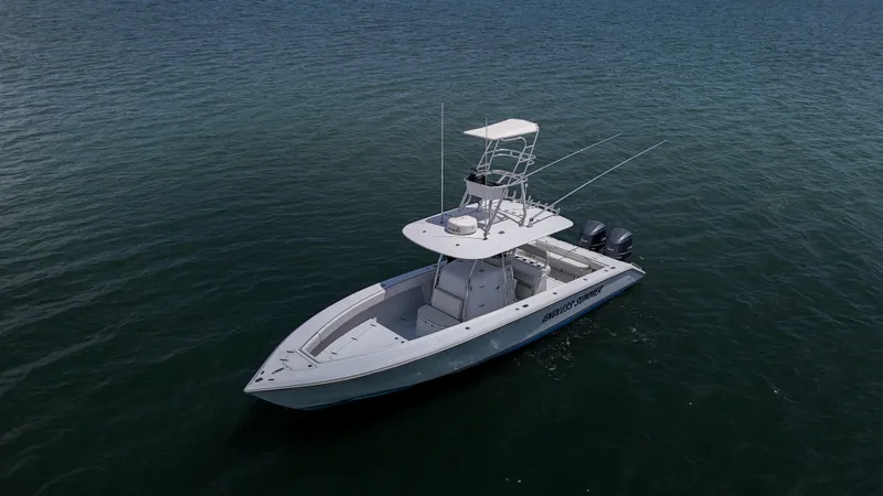  Yacht Photos Pics 2001 Venture 34 boat on calm water, featuring dual outboard motors and a tower.