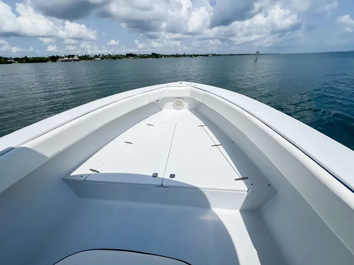  Yacht Photos Pics Bow view of 2001 Venture 34 boat on calm water under cloudy sky.