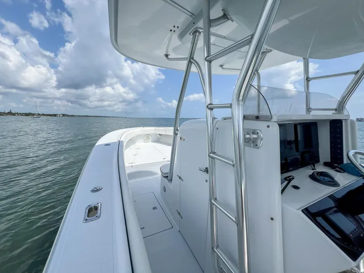  Yacht Photos Pics 2001 Venture 34 boat on water, featuring sleek design and modern controls under a cloudy sky.