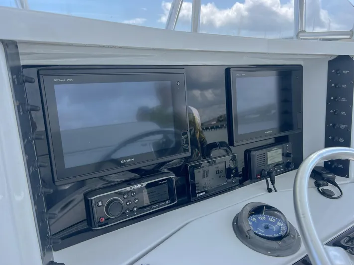  Yacht Photos Pics Control panel of a 2001 Venture 34 boat with navigation screens and compass.