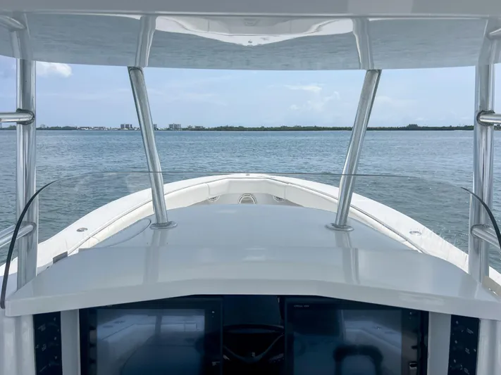  Yacht Photos Pics 2001 Venture 34 boat on calm water, viewed from helm, clear sky in background.