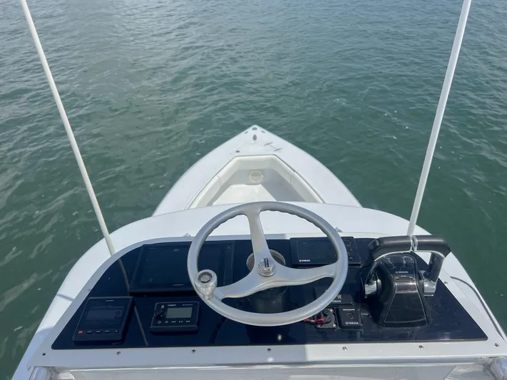  Yacht Photos Pics Steering console of a 2001 Venture 34 boat on calm water.