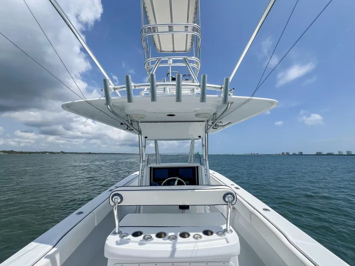  Yacht Photos Pics 2001 Venture 34 boat on open water, featuring a sleek helm and fishing rod holders.