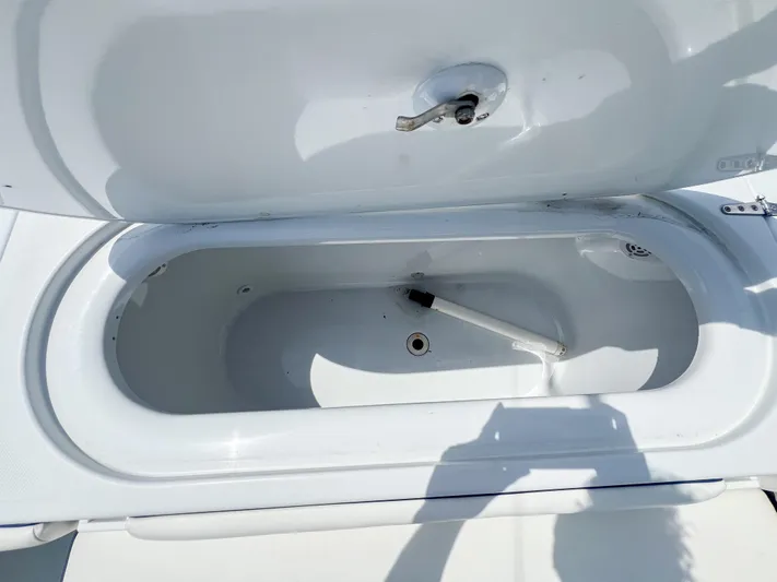  Yacht Photos Pics Open storage compartment on a 2001 Venture 34 boat, showing interior details.