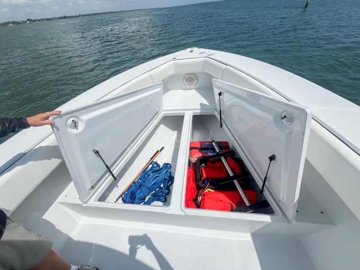  Yacht Photos Pics Open storage compartments on a 2001 Venture 34 boat, containing ropes and life jackets.
