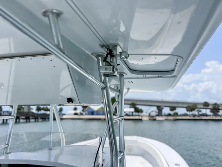  Yacht Photos Pics 2001 Venture 34 boat with metal framework, docked near a bridge on a sunny day.
