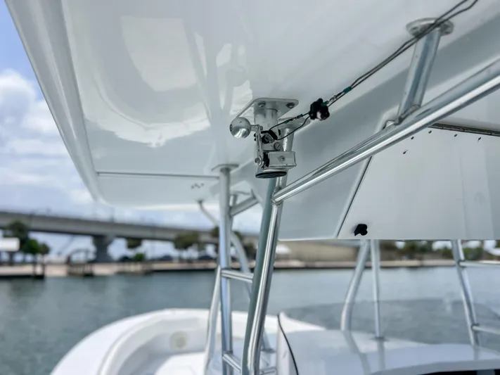  Yacht Photos Pics Close-up of a 2001 Venture 34 boat's T-top structure with a scenic waterway background.