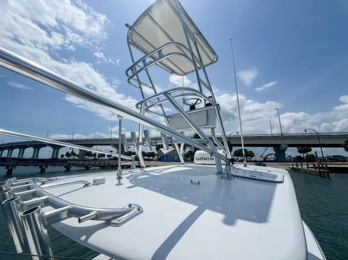  Yacht Photos Pics 2001 Venture 34 boat with tower, docked near a bridge under a clear sky.