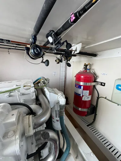 Aubreezy Yacht Photos Pics Engine room of 2007 Luhrs 41 Express with fishing rods and fire extinguisher.
