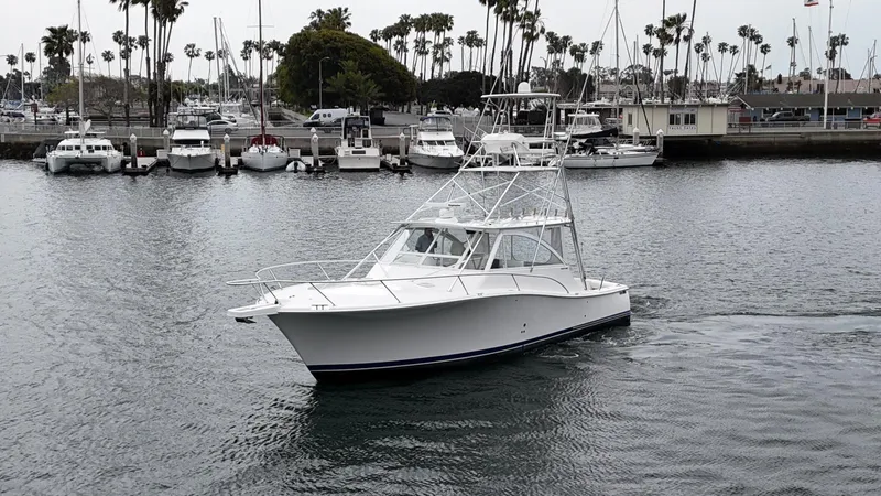 Aubreezy Yacht Photos Pics 2007 Luhrs 41 Express boat cruising in a marina with palm trees in the background.