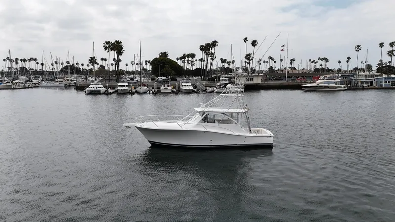 Aubreezy Yacht Photos Pics 2007 Luhrs 41 Express boat in a marina with palm trees and cloudy sky.