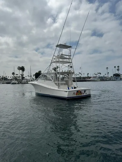 Aubreezy Yacht Photos Pics 2007 Luhrs 41 Express boat on calm water with cloudy sky background.