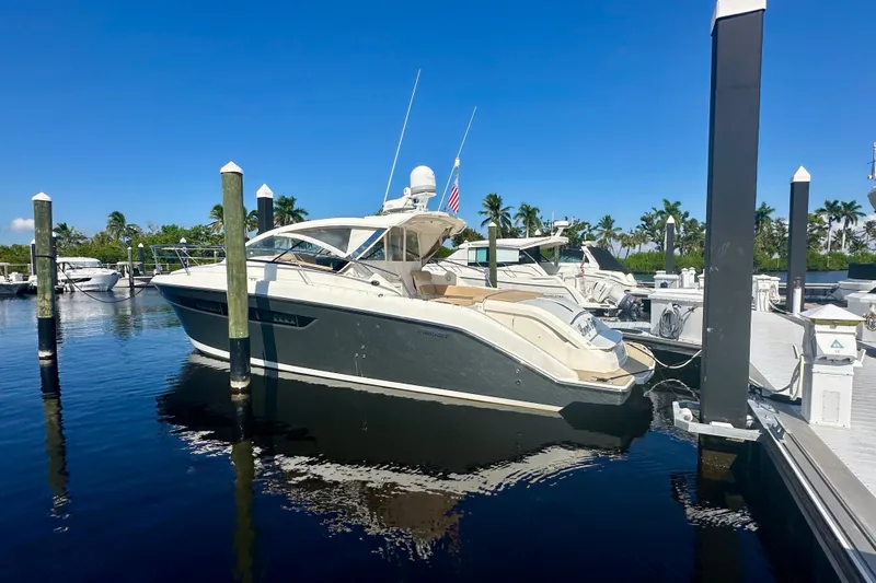  Yacht Photos Pics 2015 Pursuit SC 365i Sport Coupe docked at marina under clear blue sky.
