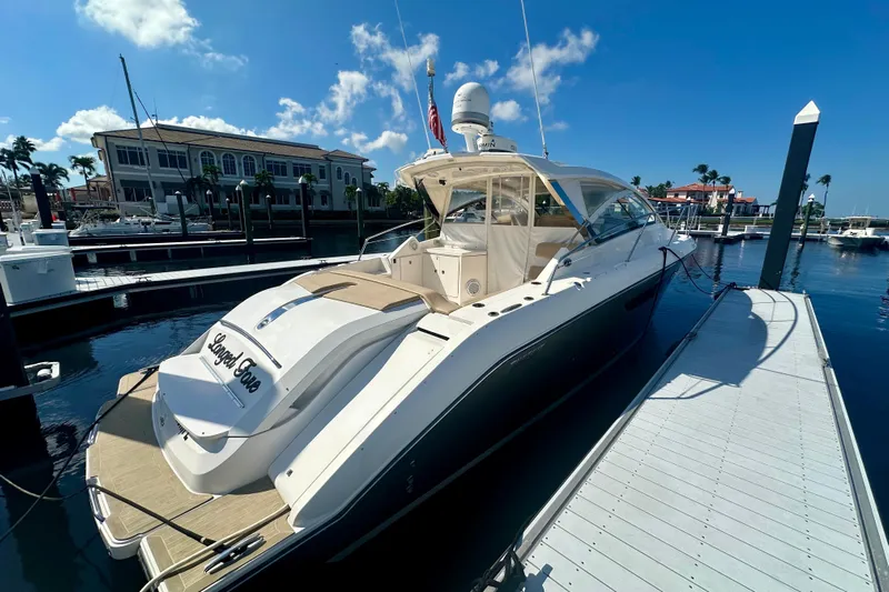  Yacht Photos Pics 2015 Pursuit SC 365i Sport Coupe docked at marina under clear blue sky.