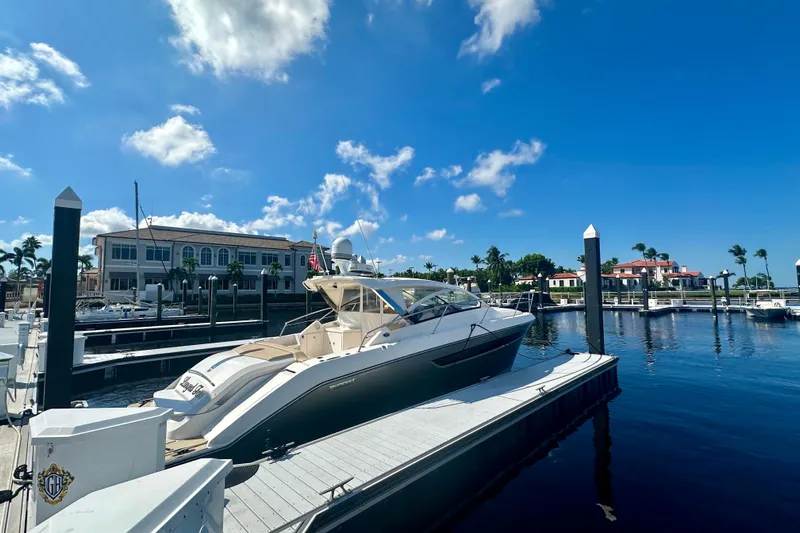  Yacht Photos Pics 2015 Pursuit SC 365i Sport Coupe docked at a marina under a clear blue sky.