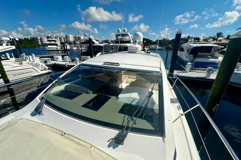  Yacht Photos Pics 2015 Pursuit SC 365i Sport Coupe docked at marina under clear blue sky.