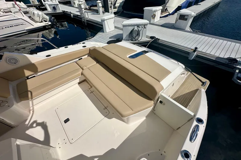  Yacht Photos Pics 2015 Pursuit SC 365i Sport Coupe boat with beige seating at a marina dock.