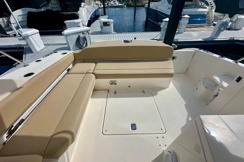  Yacht Photos Pics 2015 Pursuit SC 365i Sport Coupe boat interior with beige seating at marina.