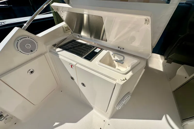  Yacht Photos Pics 2015 Pursuit SC 365i Sport Coupe boat kitchenette with sink and grill.
